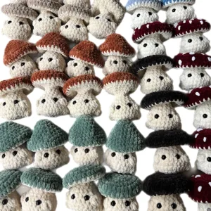 Multiple handmade crochet mushrooms in different colors